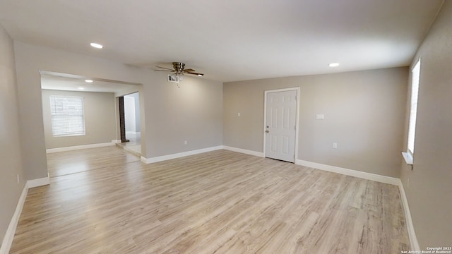 spare room with ceiling fan and light wood-type flooring