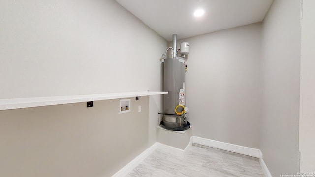 clothes washing area featuring washer hookup, gas water heater, and hookup for an electric dryer