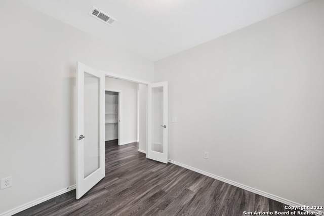 unfurnished room featuring dark wood-type flooring