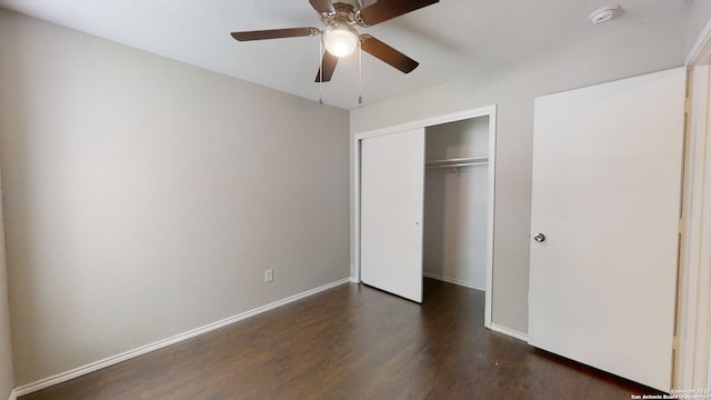 unfurnished bedroom with dark hardwood / wood-style floors, a closet, and ceiling fan