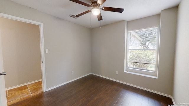 spare room featuring ceiling fan and dark hardwood / wood-style floors