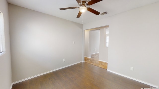 empty room featuring wood-type flooring and ceiling fan