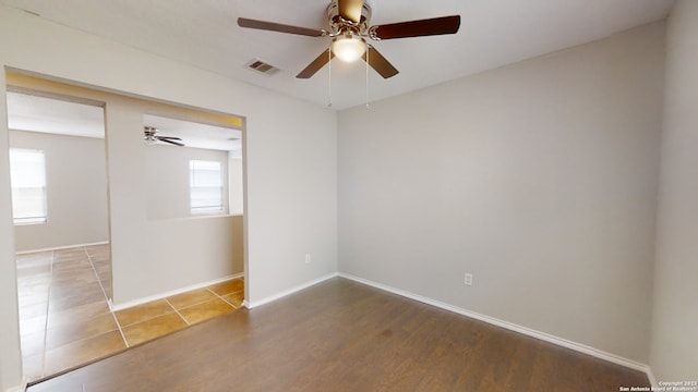 spare room featuring hardwood / wood-style flooring and ceiling fan