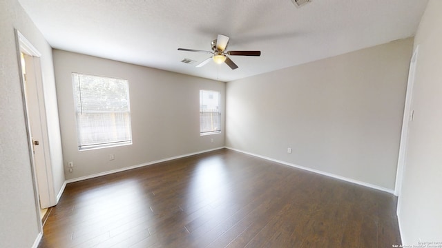 empty room featuring dark hardwood / wood-style floors and ceiling fan