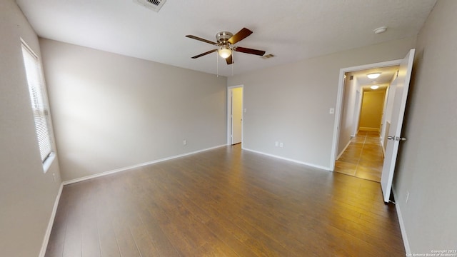 empty room featuring hardwood / wood-style flooring and ceiling fan