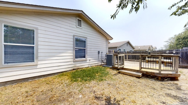 view of home's exterior featuring a wooden deck and central AC