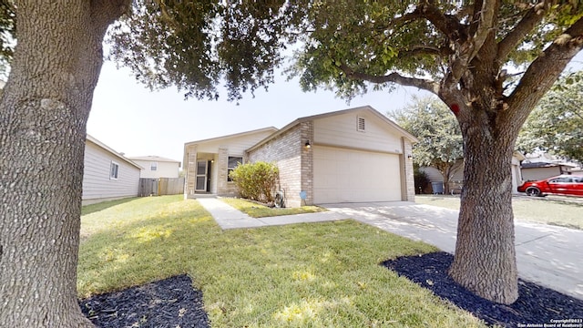 single story home with a garage and a front lawn