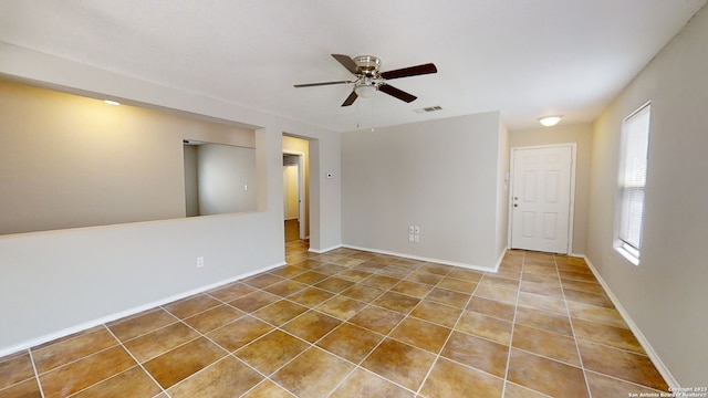 unfurnished room featuring ceiling fan and tile patterned flooring