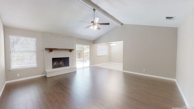 unfurnished living room featuring ceiling fan, vaulted ceiling with beams, plenty of natural light, dark hardwood / wood-style floors, and a fireplace