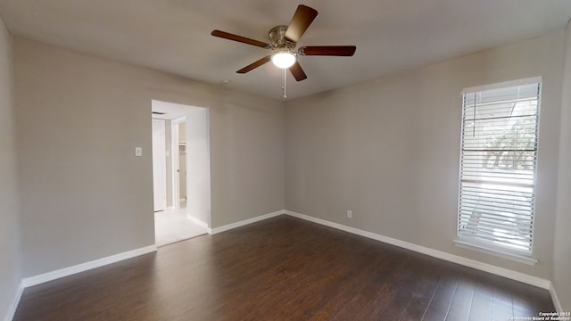 unfurnished room with a healthy amount of sunlight, dark wood-type flooring, and ceiling fan