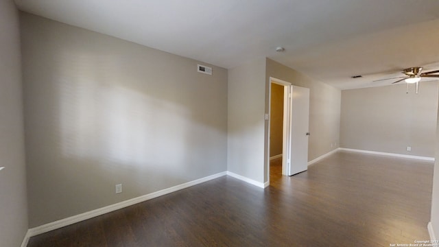 empty room with dark wood-type flooring and ceiling fan