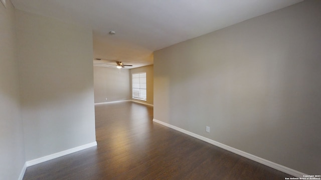 spare room with dark hardwood / wood-style flooring and ceiling fan