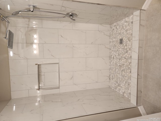 bathroom with tiled shower