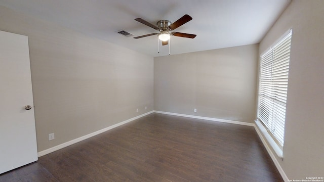 spare room with ceiling fan and dark hardwood / wood-style flooring