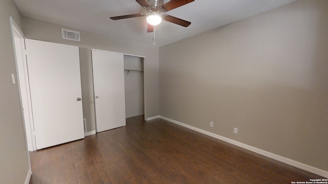 unfurnished bedroom featuring dark wood-type flooring, ceiling fan, and a closet