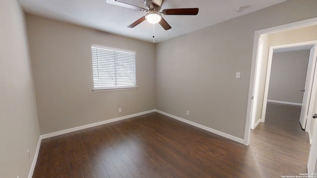 spare room with dark hardwood / wood-style flooring and ceiling fan