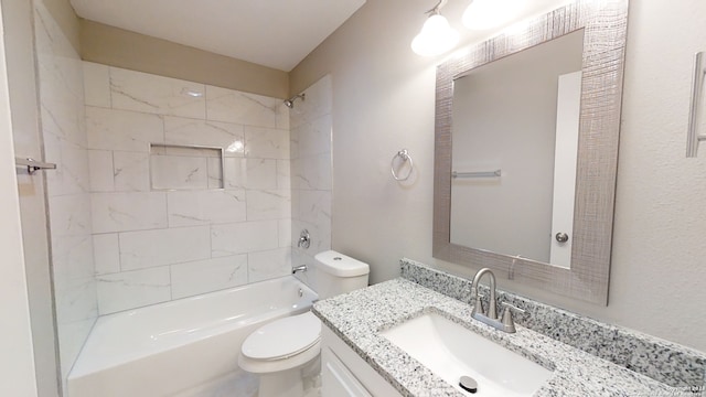 full bathroom with tiled shower / bath, vanity, and toilet