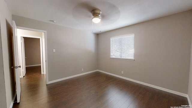 unfurnished room featuring dark hardwood / wood-style flooring and ceiling fan