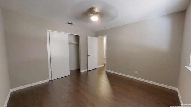 unfurnished bedroom featuring dark hardwood / wood-style floors, a closet, and ceiling fan