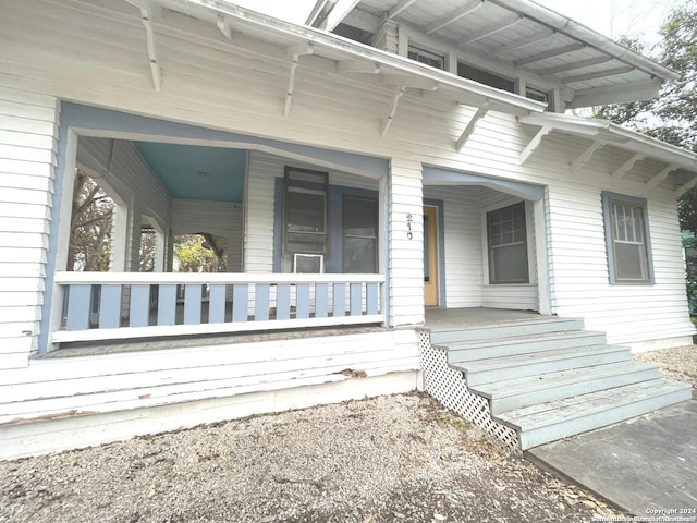 doorway to property featuring covered porch