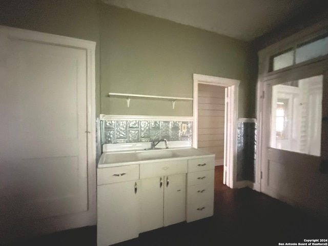 kitchen featuring white cabinetry and sink