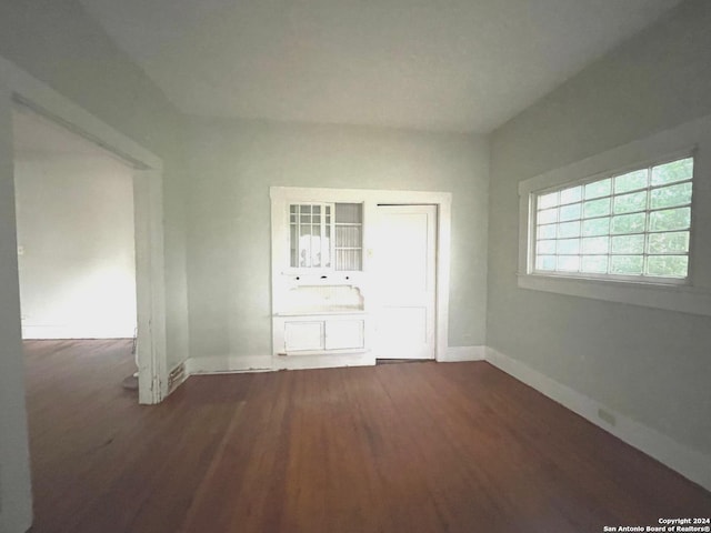 unfurnished bedroom featuring dark hardwood / wood-style flooring