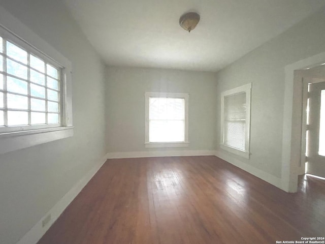 spare room featuring dark hardwood / wood-style floors