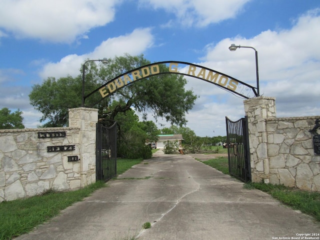 view of road featuring a gated entry, concrete driveway, and a gate
