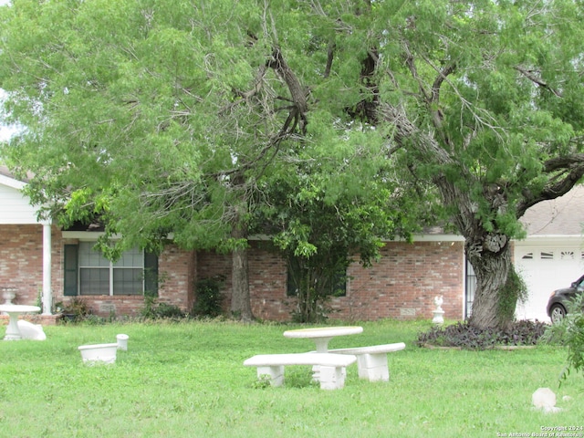 exterior space with a garage and a front yard