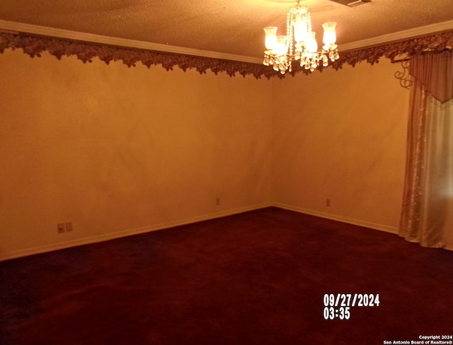 carpeted spare room featuring a textured ceiling, crown molding, and a chandelier