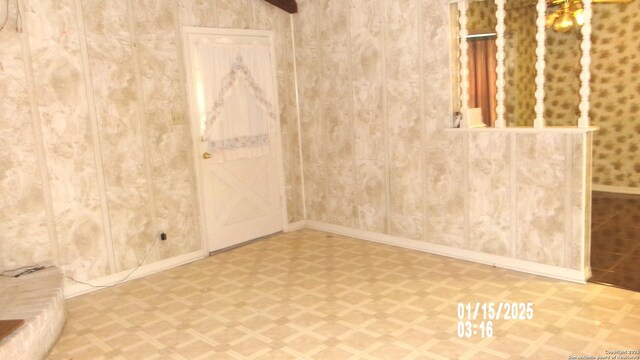 empty room with tile patterned floors and baseboards