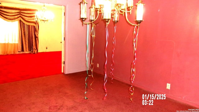 dining room featuring carpet and an inviting chandelier