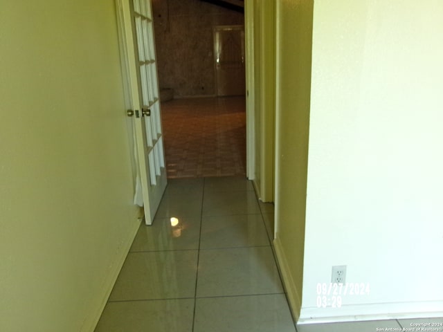 hall with light tile patterned floors