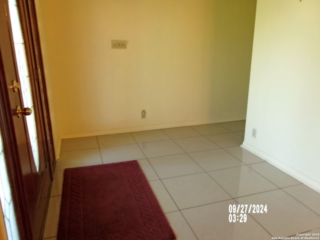 empty room with light tile patterned floors