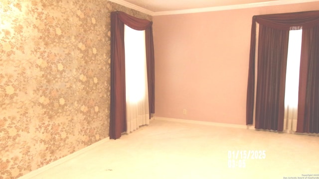 unfurnished room with baseboards, wallpapered walls, and crown molding