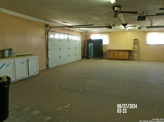 garage featuring a garage door opener and ceiling fan