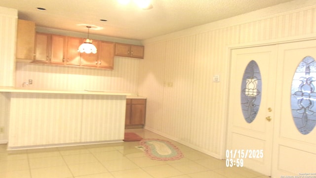 kitchen with decorative light fixtures and light tile patterned floors