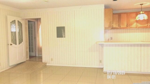 kitchen with radiator, light tile patterned floors, electric panel, and pendant lighting