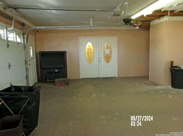 garage featuring a garage door opener and ceiling fan