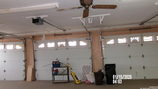 garage with a garage door opener and ceiling fan