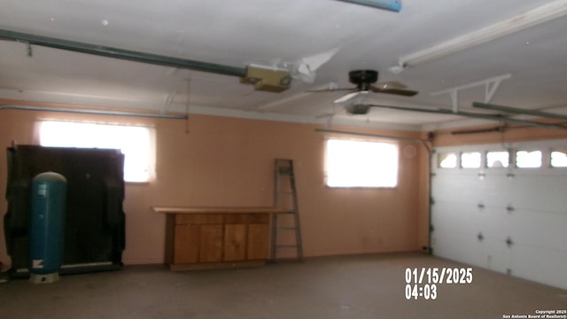 garage featuring a garage door opener and ceiling fan