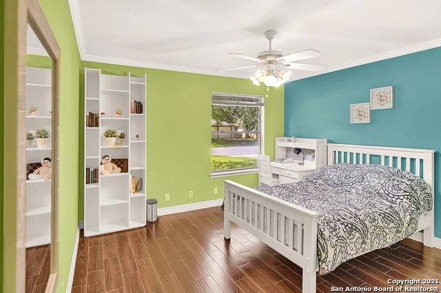 bedroom featuring hardwood / wood-style flooring, ornamental molding, and ceiling fan