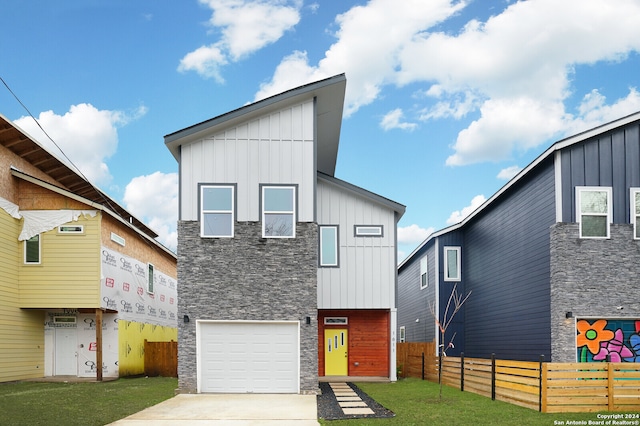 view of front of property featuring a garage and a front yard