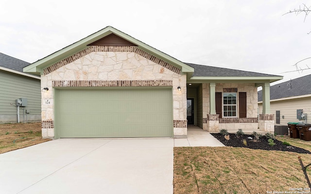 single story home featuring cooling unit and a garage