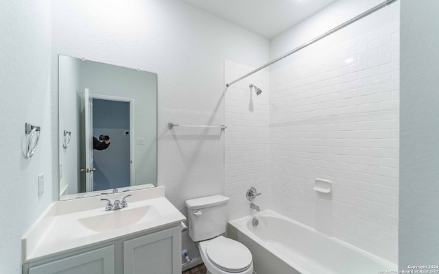 full bathroom with tiled shower / bath combo, vanity, and toilet