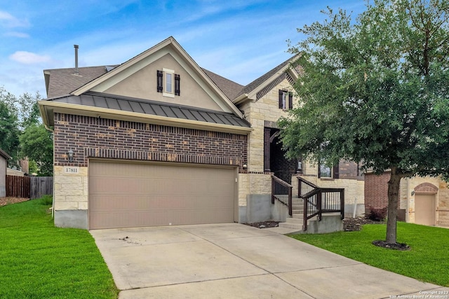 view of front of property featuring a garage and a front lawn