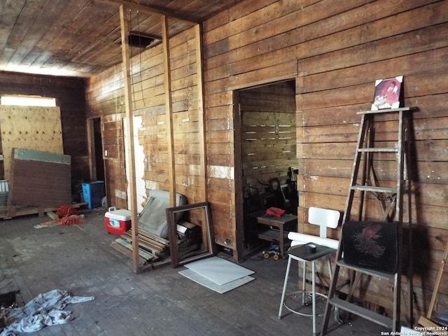 miscellaneous room with wood ceiling and wood walls