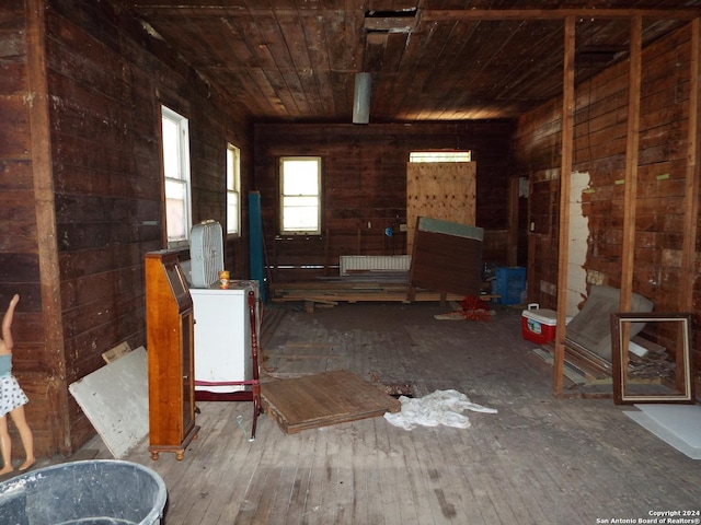 miscellaneous room featuring wood-type flooring, wooden ceiling, and wood walls