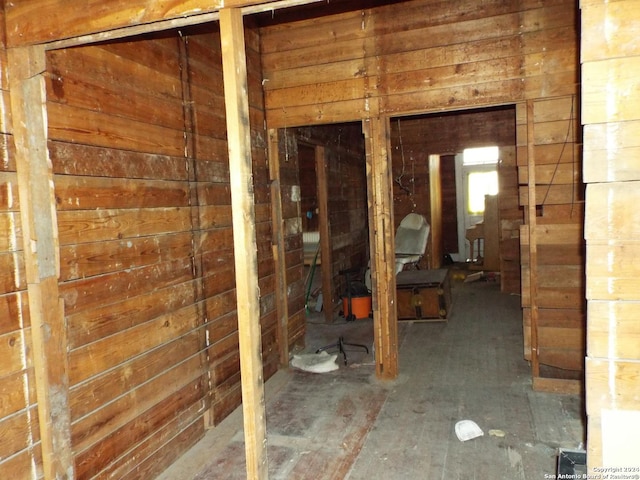 miscellaneous room featuring wood walls