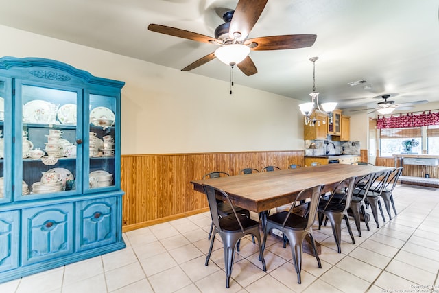 dining room featuring sink, ceiling fan with notable chandelier, and light tile patterned floors